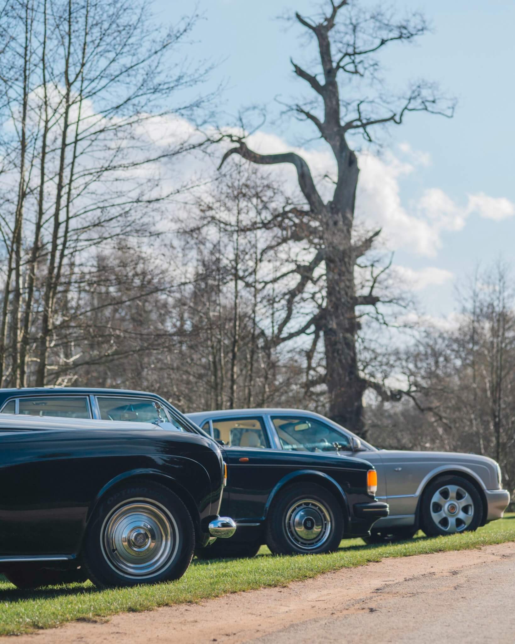 3 vintage wedding cars parked up