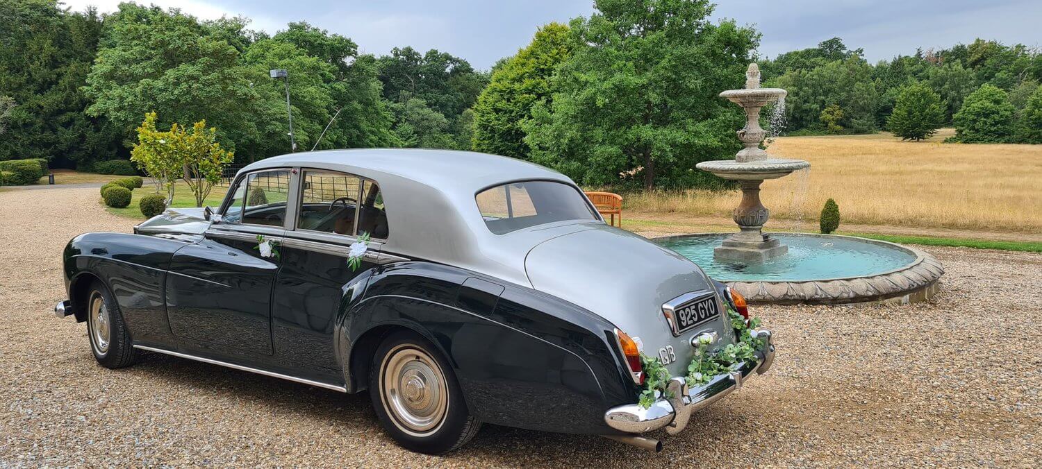 Dark Blue and Silver car on gravel